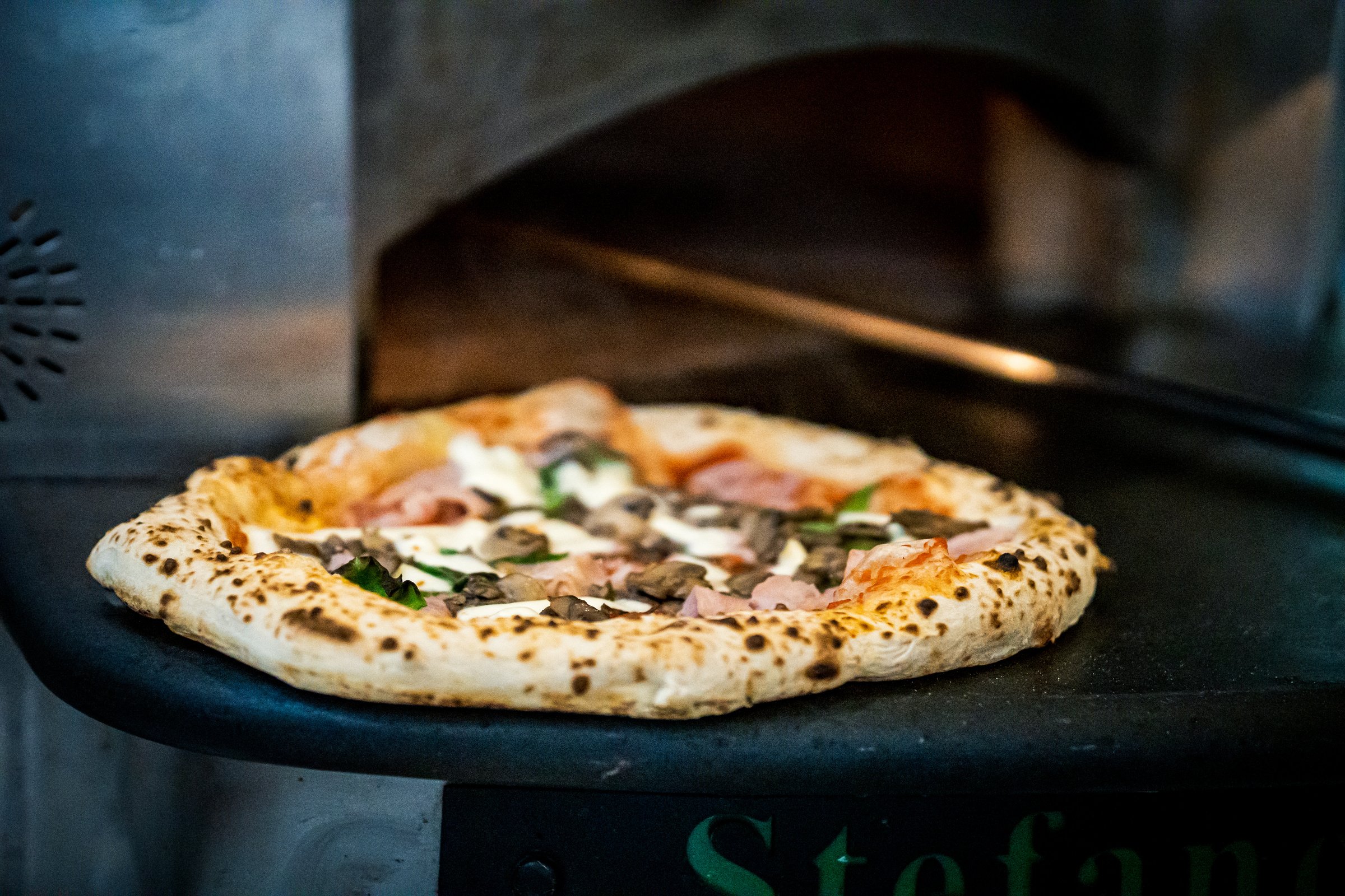 Pizzaiolo prepares Neapolitan pizza